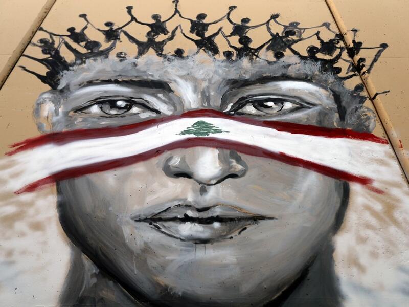 A graffiti is sprayed on a wall in Lebanon's capital Beirut on November 5, 2019. Since October 17, the chanting of tens of thousands of Lebanese denouncing the political elite have shaken the normally staid district around two Beirut squares, Martyrs' and Riad Al Solh. JOSEPH EID / AFP