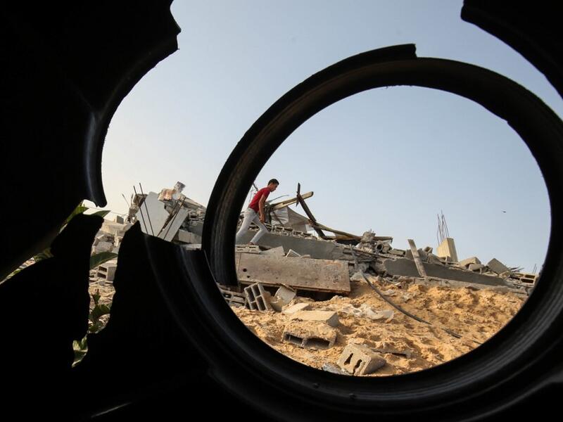 Palestinians check the remains of a house destroyed in an Israeli air strike at Khan Yunis in the southern Gaza Strip November 13, 2019. SAID KHATIB / AFP