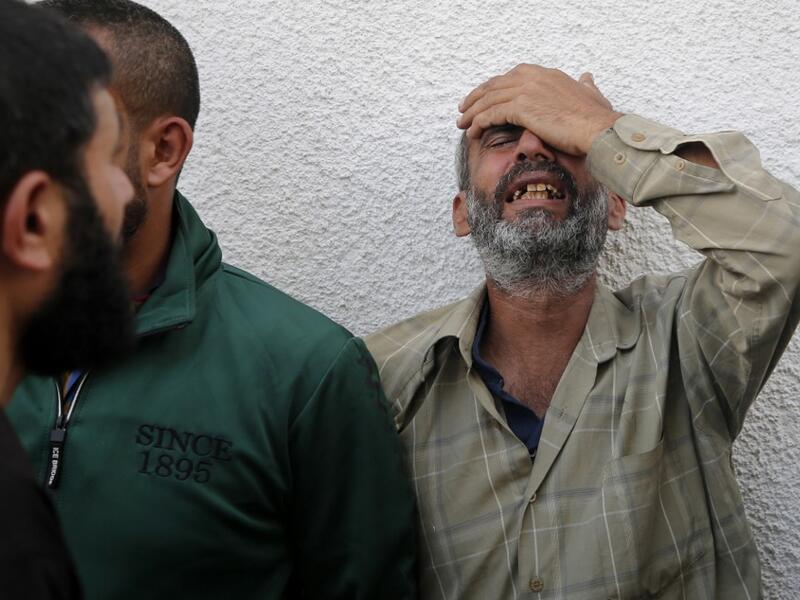 Palestinian men mourn outside the mortuary of Gaza City's Al-Shifa hospital on November 13, 2019, after two more Palestinians were killed in the morning in an Israeli strike, according to Gaza's health ministry, as Israel said it was targeting rocket-launching squads and militant sites. The deaths brought the Gaza toll to 18 people killed since an exchange of fire began on November 12 with an Israeli targeted strike on an Islamic Jihad commander sparking retaliatory rocket launches  ANAS BABA / AFP