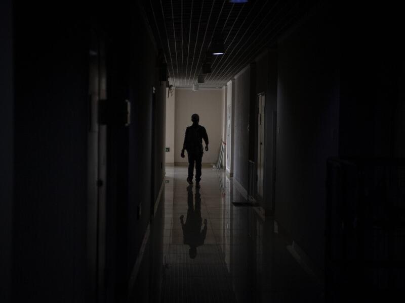 This photo taken on October 23, 2019 shows pet detective Sun Jinrong searching for a missing cat in a residential compound in Beijing. Private sleuth Sun Jinrong brings heat detectors, tiny surveillance cameras, and a blowdart loaded with a tranquiliser to his search for one desperate client's missing loved one: A cat named Duoduo.  NOEL CELIS / AFP