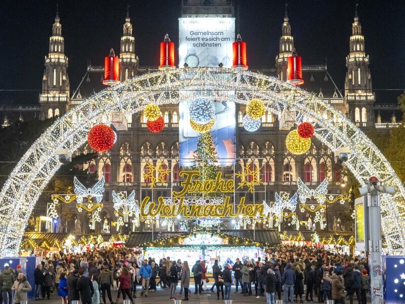 Visitors explore a Christmas market in front of Vienna's city hall in Vienna, Austria on November 19, 2019. JOE KLAMAR / AFP