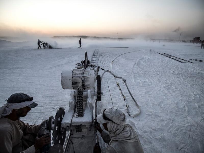 Labourers work at the "White Mountain" limestone extraction quarry site near Egypt's southern city of Minya, some 265 kilometres south of the capital, on November 13, 2019. Covered in fine white dust, labourers at the so-called "White Mountain" off Minya toil in shifts amidst brutal conditions with little workplace safety for paltry pay. They handle dangerous machinery with finesse, and shrug off the dangers of a job where a mistake can prove fatal. Khaled DESOUKI / AFP