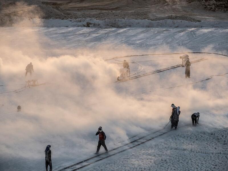 Labourers work at the "White Mountain" limestone extraction quarry site near Egypt's southern city of Minya, some 265 kilometres south of the capital, on November 13, 2019. Covered in fine white dust, labourers at the so-called "White Mountain" off Minya toil in shifts amidst brutal conditions with little workplace safety for paltry pay. They handle dangerous machinery with finesse, and shrug off the dangers of a job where a mistake can prove fatal. Khaled DESOUKI / AFP