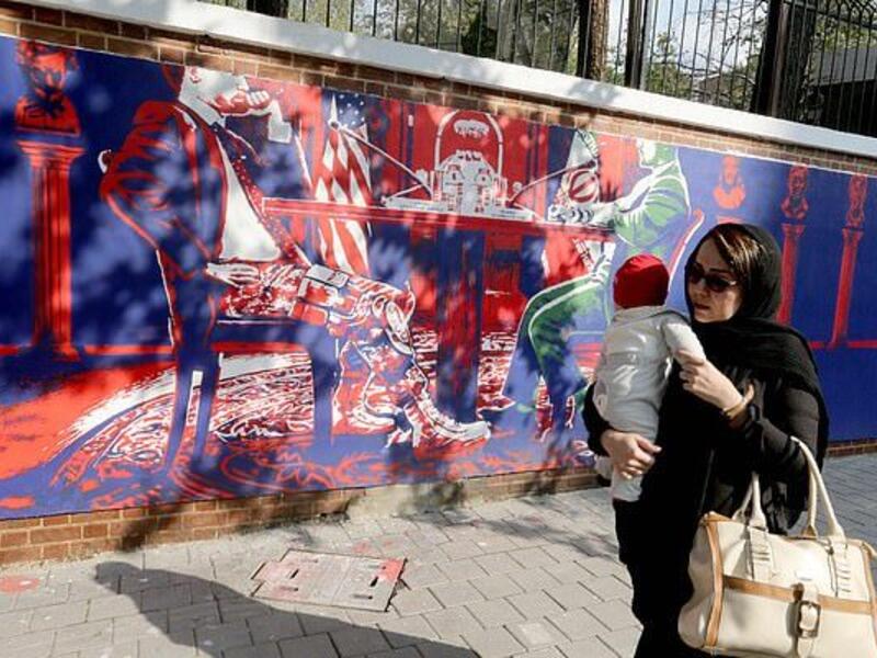 Another mural shows Iranian and American politicians sitting at a table in the White House  (AFP)