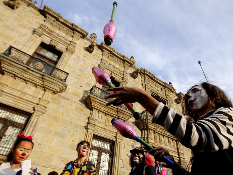 A group of clowns play during the International Clown Day in Guadalajara, Mexico, on December 10, 2019. Ulises Ruiz / AFP