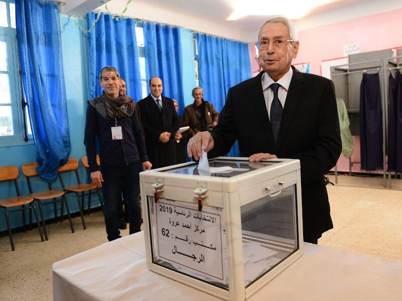 Algeria's interim president Abdelkader Bensalah casts his vote during the presidential election on December 12, 2019 at a polling station in Algiers. Five candidates are running in Algeria's presidential election to replace ousted Algerian president Abdelaziz Bouteflika. AFP