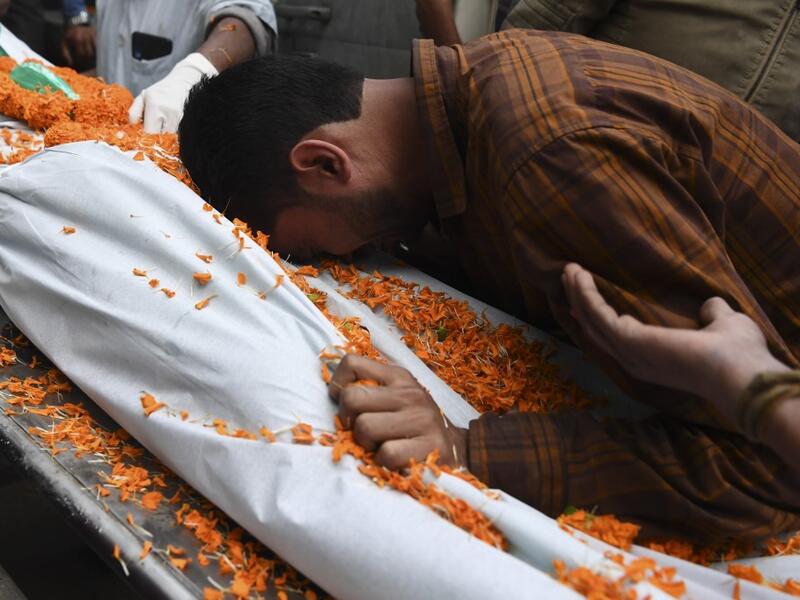 A relative mourns next to the dead body of Ishwor Nayak, 25, who was killed after police fired during a protest against the government's Citizenship Amendment Bill (CAB) three days before, in Guwahati on December 15, 2019. The death toll from violent protests in northeast India against a contentious citizenship law has risen to six, officials said on December 15, as authorities maintained internet bans and curfews to quell unrest. SAJJAD HUSSAIN / AFP