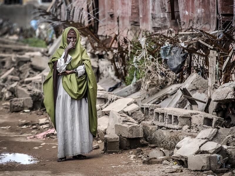 A woman reacts while looking at the destruction left after heavy rains and floods in the school in front of her house in Beledweyne, Somalia, on December 14, 2019. The rains have inundated big areas surrounding Beledweyne area forcing thousands of people to leave their houses and look for humanitarian assistance while living in displacement camps. Due to climate change and human activities, cycles of floods and droughts have become more recurrent and completely unpredictable in Somalia exposing hundreds of 