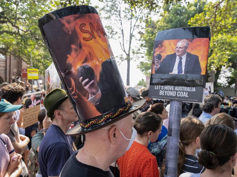 Demonstrators attend a climate protest in Sydney on December 19, 2019. Protesters marched on Australian Prime Minister Scott Morrison's official residence in Sydney to demand curbs on greenhouse gas emissions and highlight his absence on an overseas holiday as bushfires burned across the region. Wendell TEODORO / AFP