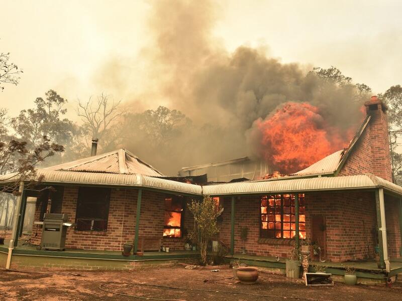 A property burns from bushfires in Balmoral, 150 kilometres southwest of Sydney on December 19, 2019. A state of emergency was declared in Australia's most populated region on December 19, as a record heat wave fanned unprecedented bushfires. PETER PARKS / AFP