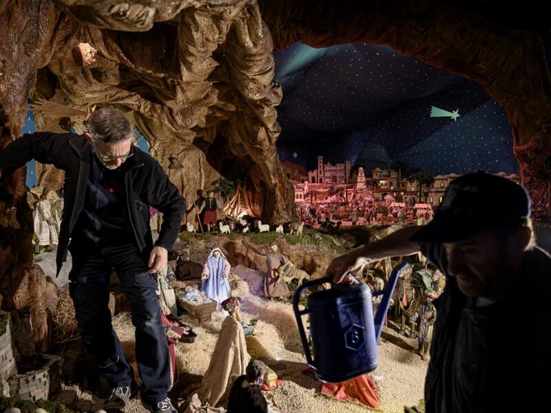 Volunteers set nativity figures at the 43rd edition of the "Presepio of Cavallermaggiore", a 300sqm Christmas Nativity crib in the Oratorio San Michele on December 20, 2019 in Cavallermaggiore, near Cuneo, Northwestern Italy. The "Presepio" is made by ten volunteers who every year spend 3 months to build a new edition with hundred of figures. MARCO BERTORELLO / AFP