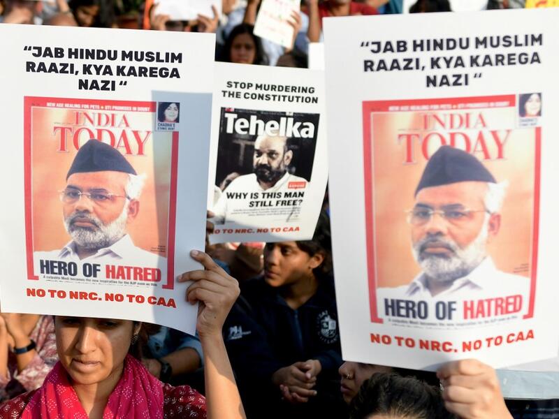 Protesters hold placards during a demonstration held against India's new citizenship law at the Town Hall in Bangalore on December 22, 2019. Prime Minister Narendra Modi sought on December 22 to reassure India's Muslims as a wave of deadly protests against a new citizenship law put his Hindu nationalist government under pressure like never before. Manjunath Kiran / AFP