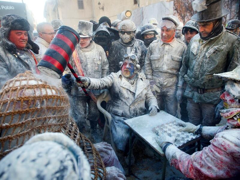 Revellers dressed in mock military garb take part in the "Els Enfarinats" battle in the southeastern Spanish town of Ibi on December 28, 2019. During this 200-year-old traditional festival participants known as Els Enfarinats (those covered in flour) dress in military clothes and stage a mock coup d'etat as they battle using flour, eggs and firecrackers outside the city town hall as part of the celebrations of the Day of the Innocents, a traditional day in Spain for pulling pranks. JAIME REINA / AFP