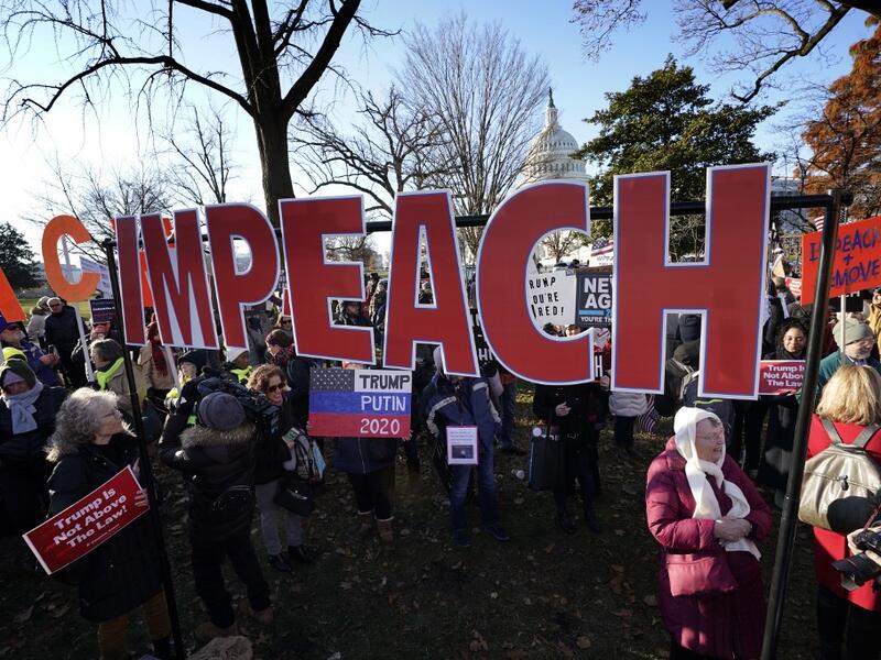 Protesters supporting the impeachment of U.S. President Donald Trump gather outside the U.S. Capitol December 18, 2019 in Washington, DC. Later today the U.S. House of Representatives is expected to vote on two articles of impeachment against Trump charging him with abuse of power and obstruction of Congress. Win McNamee/Getty Images/AFP