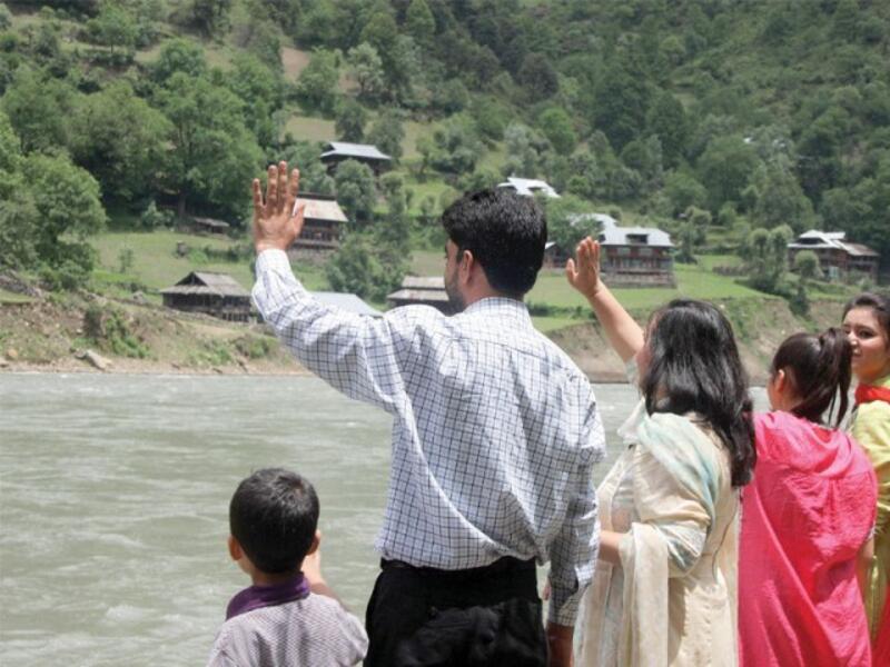 Families wave to their relatives on the Indian side of the Neelum River. (AFP/ File Photo) Families wave to their relatives on the Indian side of the Neelum River. (AFP/ File Photo)