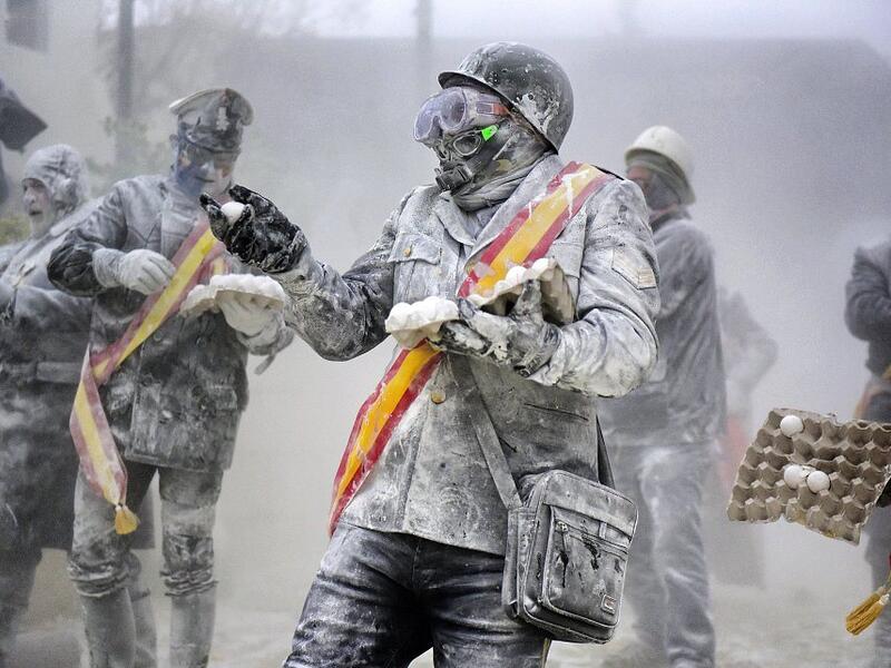 The Els Enfarinats festival takes place every year in Spain and sees two groups of residents cover each other and the entire town white with egg and flour (Twitter)