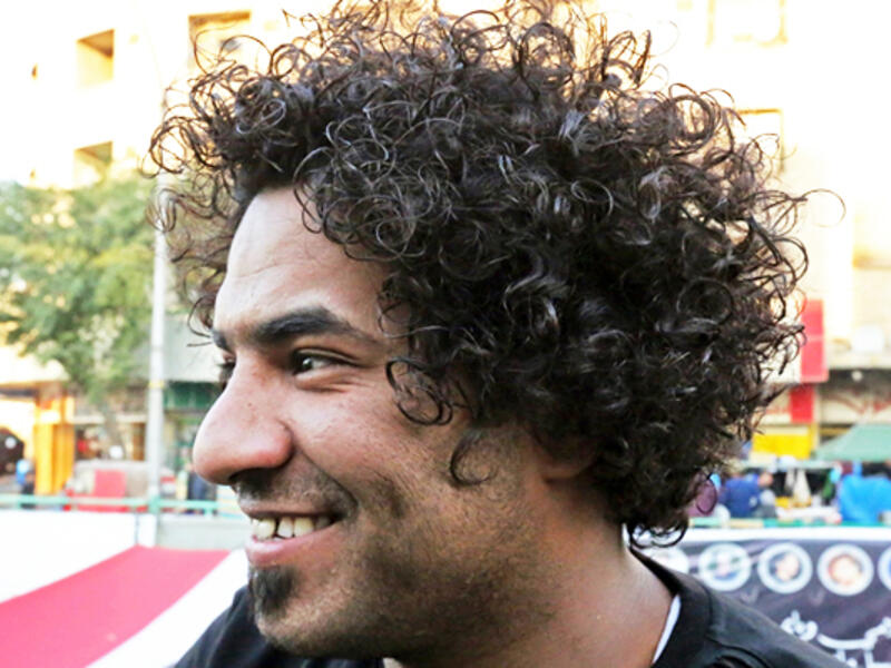 An Iraqi anti-government protestor poses with a distinct hairstyle at Tahrir Square in central Baghdad on December 23, 2019. Since the start of Iraq's anti-government protests on October 1, one thing strikes the eye perhaps above all else -- the unbridled hairstyles young men sport. High quiffs, tight fades and loads of attitude -- it is quite the male beauty pageant. SABAH ARAR / AFP