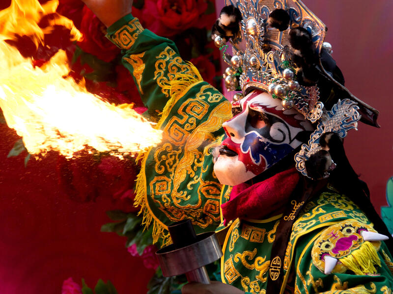 Chinese Opera actor perform spitting fire in the traditional face-changing (Shutterstock)	 