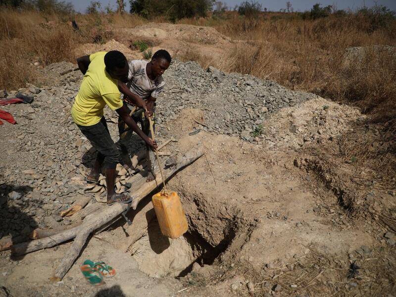 Miners work at a mining site in Anka near Gusau, on December 4,2019. For generations, the mineral-rich earth of Nigeria's Zamfara state has provided families living here with a way to make ends meet. But in recent years their trade has become increasingly unsafe. The mines lie within the reach of heavily-armed groups -- dubbed "bandits" by the local authorities -- that have been terrorising this remote region.  Kola Sulaimon / AFP
