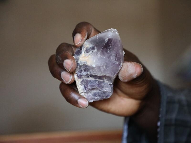 Ayuba Ahmad Muhammed, secretary of the Zamfara State Gold Buyers and Sellers, displays a mined mineral in Gusau, on December 5, 2019. For generations, the mineral-rich earth of Nigeria's Zamfara state has provided families living here with a way to make ends meet. Kola Sulaimon / AFP