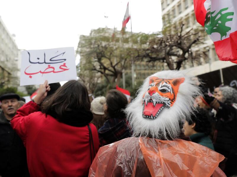 A Lebanese anti-government demonstrator wears an angry tiger mask during a rally in front of the central bank building in the capital Beirut on December 30, 2019. (AFP/ File Photo)