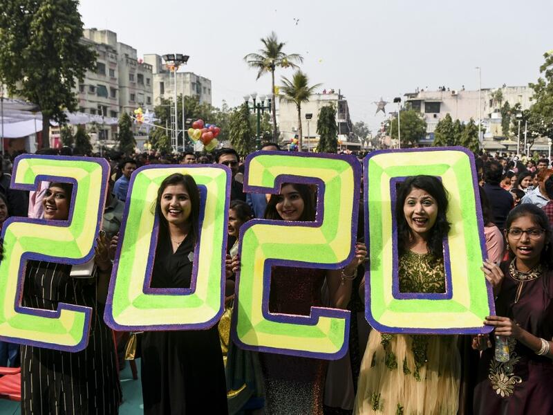 Christians react as they pose holding '2020' numericals signs on the occasion of the New Year celebrations at the Methodist Church Maninagar in Ahmedabad marking New Year, on January 1, 2020. SAM PANTHAKY / AFP