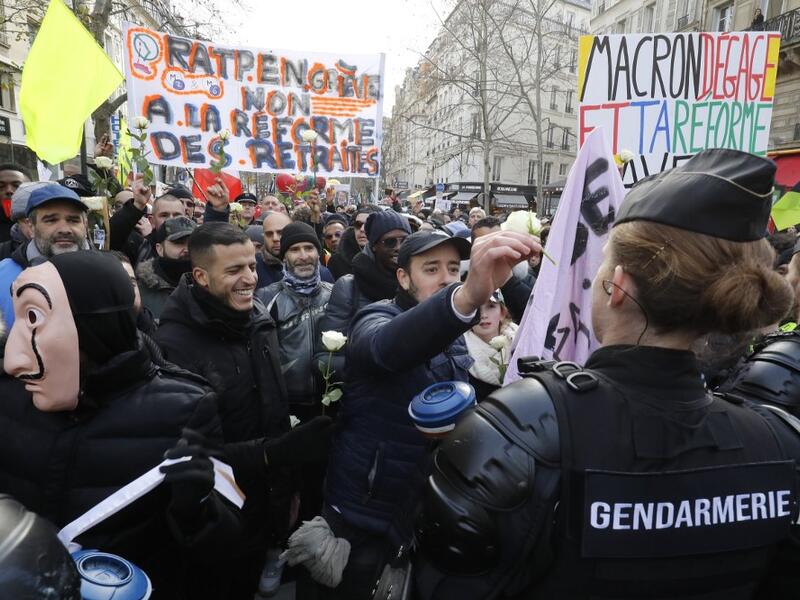 People hold banners reading " RATP on strike, no to pension reforms " during a protest called by French national trade union General Confederation of Labour (CGT), on January 4, 2020, in Paris. FRANCOIS GUILLOT / AFP