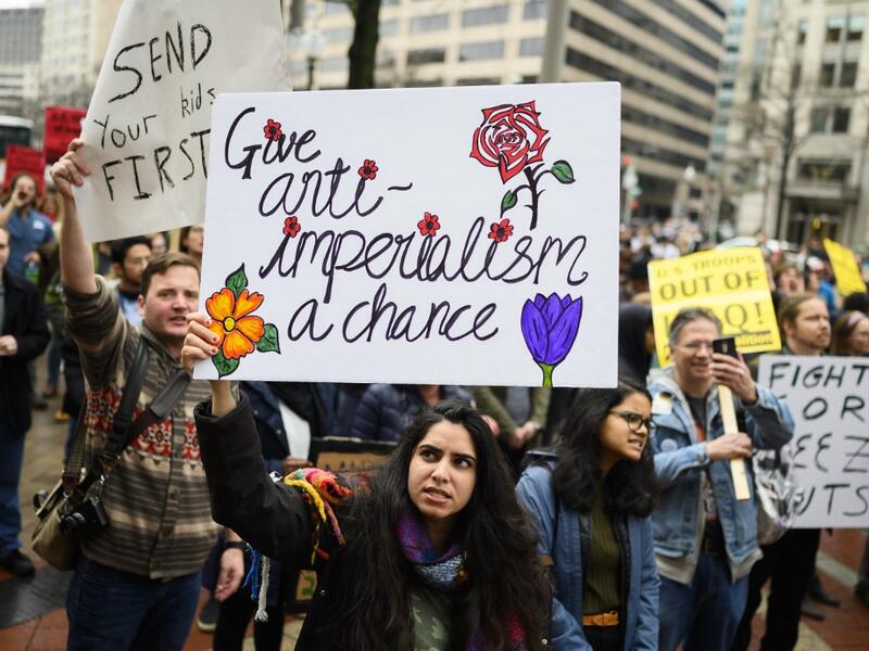 Anti-war activist demonstrate outside the Trump International Hotel in Washington, DC, on January 4, 2020. Demonstrators are protesting the US drone attack which killed Iran's Major General Qasem Soleimani in Iraq on January 3, a dramatic escalation in spiralling tensions between Iran and the US, which pledged to send thousands more troops to the region. ANDREW CABALLERO-REYNOLDS / AFP