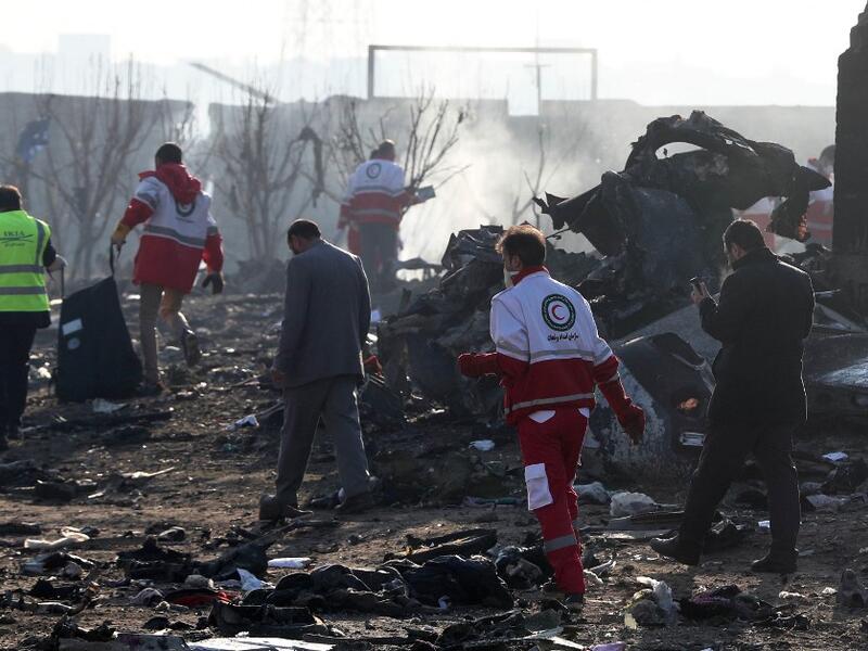 Rescue teams work amidst debris after a Ukrainian plane carrying 176 passengers crashed near Imam Khomeini airport in the Iranian capital Tehran early in the morning on January 8, 2020, killing everyone on board. The Boeing 737 had left Tehran's international airport bound for Kiev, semi-official news agency ISNA said, adding that 10 ambulances were sent to the crash site. AFP