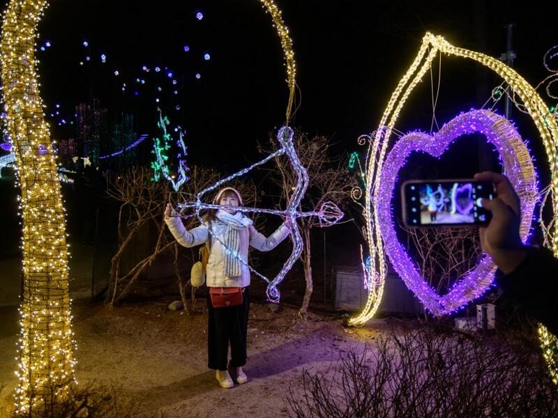 In a photo taken on January 11, 2020 visitors look at an annual light display at the 'Garden on Morning Calm', near Gapyeong, east of Seoul. Ed JONES / AFP