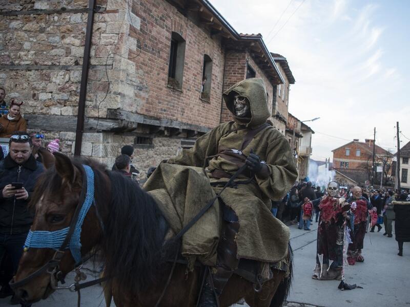 Masked revellers take part in a carnival procession through the south-western North Macedonian village of Vevcani, on January 13, 2020. The Vevcani carnival is 1.400 years old and is held every year on the eve of the feast of Saint Basil (January 14), which also marks the beginning of the New Year according to the Julian calendar, observed by the Macedonian Orthodox Church. Robert ATANASOVSKI / AFP