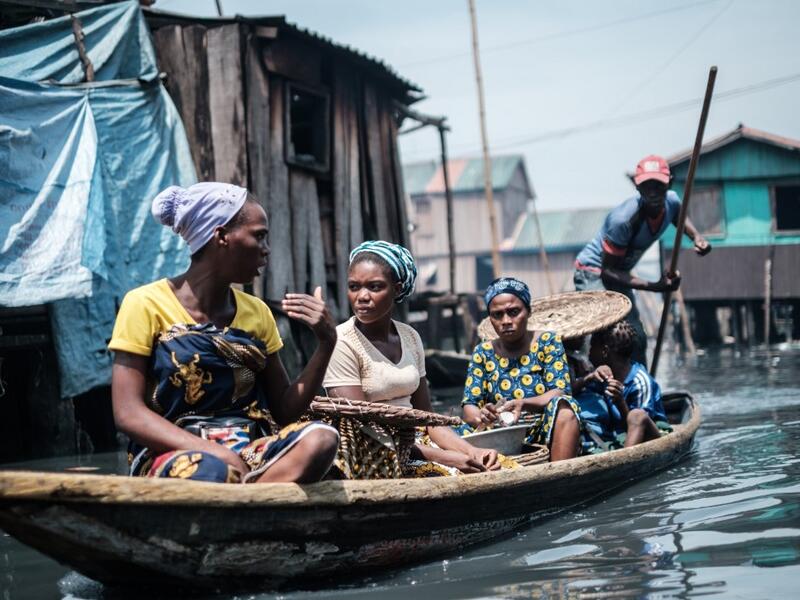 A picture taken on March 1, 2019 shows women on a boat in the Makoko waterfront community in a polluted lagoon in Lagos, Africa’s biggest megalopolis in Nigeria. The sprawling community began in the 19th century as a fishing village for immigrants who settled on the water's edge. As more arrived and land became rare, people started to move out onto the water. Over time, Makoko became a floating realm of perhaps a quarter of a million people, although the real number is anyone's guess. YASUYOSHI CHIBA / AFP
