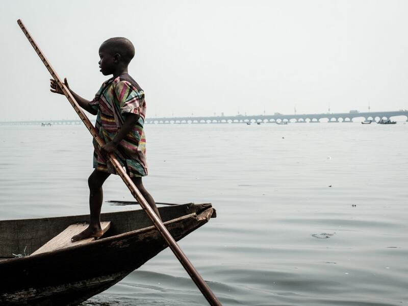 A picture taken on March 2, 2019 shows a boy steering a boat in the Makoko waterfront community in a polluted lagoon in Lagos, Africa’s biggest megalopolis in Nigeria. The sprawling community began in the 19th century as a fishing village for immigrants who settled on the water's edge. As more arrived and land became rare, people started to move out onto the water. Over time, Makoko became a floating realm of perhaps a quarter of a million people, although the real number is anyone's guess. YASUYOSHI CHIBA 