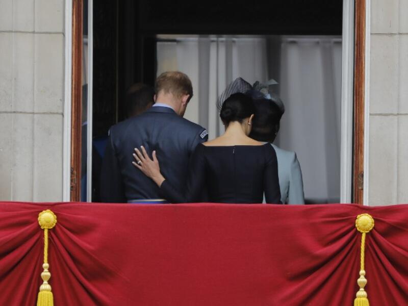 In this file photo taken on July 10, 2018 Britain's Meghan, Duchess of Sussex (R) puts her hand on Britain's Prince Harry, Duke of Sussex's back as they leave the balcony of Buckingham Palace in London. (AFP/ File Photo)