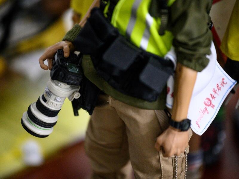 This picture taken on January 14, 2020 shows detail on a 1:6 scale action figure depicting a photographer covering the Hong Kong protests, in Hong Kong. Intricately detailed Hong Kong protester figurines have become the latest must-have collectables as toy stores recreate the pro-democracy movement's street battles with police in their shop displays.  Philip FONG / AFP