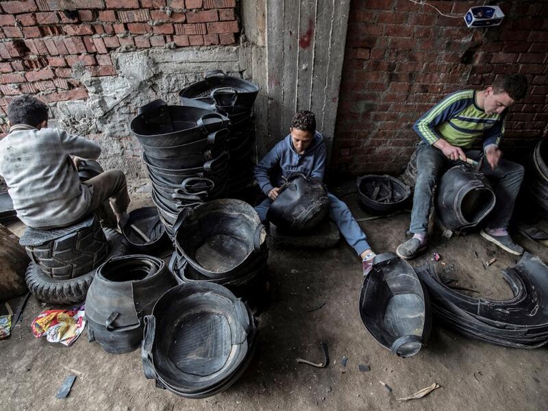 Labourers create rubber baskets from recycled tyre components at a rubber recycling workshop in the village of Mit al-Harun in Egypt's central Nile delta Gharbia Governorate, about 70 kilometres (43 miles) north of the capital, on January 14, 2020. Khaled DESOUKI / AFP