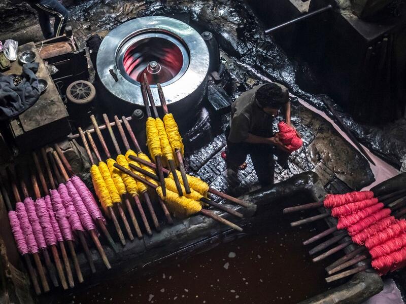 Salama and his relatives lay out the long, flowing threads, which will be used for everything from handmade shoes to rugs and drapes, and dip them in huge, piping-hot colour baths -- no gloves or masks protecting them from the dyes and chemical fumes. The workshop in Islamic Cairo has been going strong for over a hundred years. Khaled DESOUKI / AFP