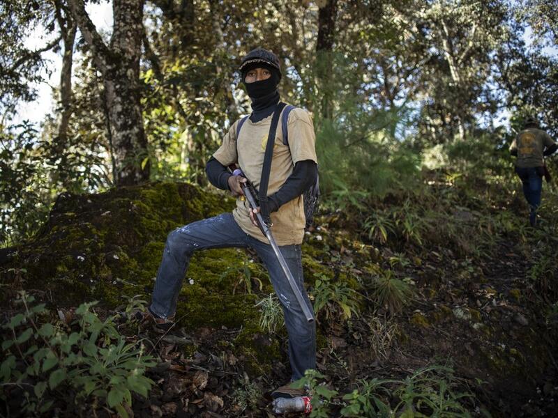 Members of the Regional Coordinator of Community Authorities (CRAC-PF) community police force patrol the village of Ayahualtempan, Guerrero State, Mexico, on January 24, 2020. The CRAC-PF vigilante group trains children as young as five so they can protect themselves from drug-related criminal groups operating in the area. Pedro PARDO / AFP