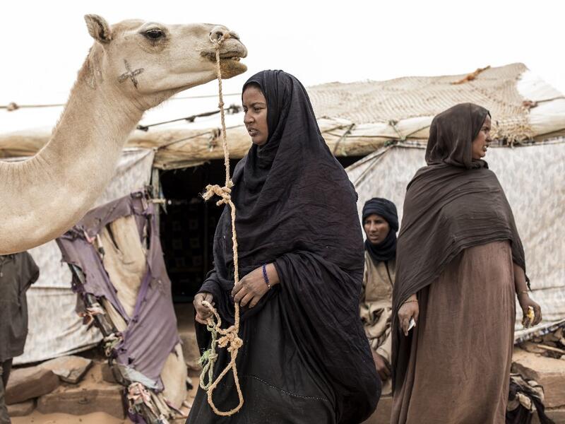 A family from the small Nemadi(hunters) tribe in Eastern Mauritania is seen at outside their families tent in the Loudeyatt Nemadi Camp on January 23, 2020. In the arid West African country of Mauritania, the way of life of the traditional group of hunters known as the Nemadi is slowly disappearing. JOHN WESSELS / AFP