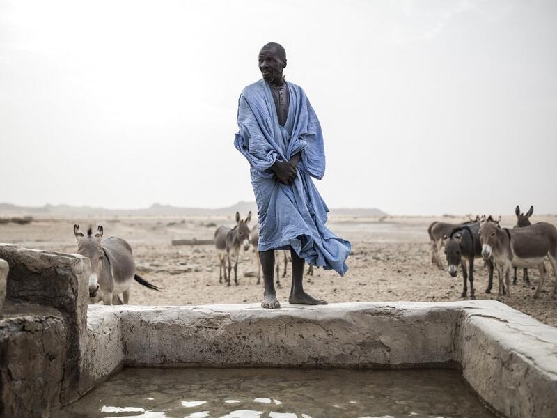 A man is seen at one of the few water wells along the caravan route from Tichitt to Aratane in Mauritania on January 25, 2020. In the arid West African country of Mauritania, the way of life of the traditional group of hunters known as the Nemadi is slowly disappearing. JOHN WESSELS / AFP