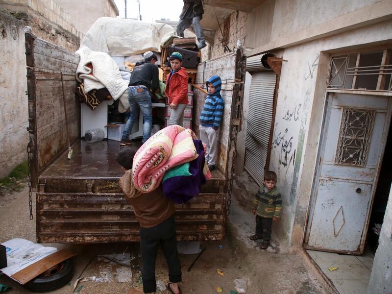 Syrians load their belongings onto a truck as they prepare to leave the town of Binnish in the northwestern province of Idlib, on February 4, 2020, amid an ongoing offensive by pro-regime forces. A Russian-backed Syrian government offensive against the country's last rebel enclave of Idlib has displaced more than half a million people in two months, according to the United Nations. The wave of displacement, which coincides with a biting winter, is one of the largest since the start of the Syrian war nearly 