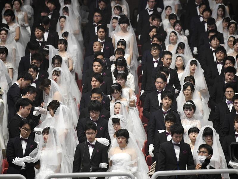 Couples attend a mass wedding ceremony organised by the Unification Church at Cheongshim Peace World Center in Gapyeong on February 7, 2020. Thousands of Unification Church couples married at a mass wedding to mark the eighth anniversary of the death of founder and self-proclaimed messiah Sun Myung Moon. Jung Yeon-je / AFP