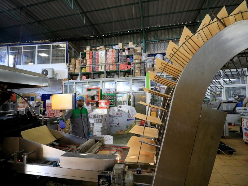 A worker monitors the production of wafers at al-Arees sweets factory in Gaza City on February 5, 2020. Al-Arees's products are Gazan but their components are not, as few of the basic raw ingredients are produced in the impoverished Mediterranean coastal strip.EMMANUEL DUNAND / AFP