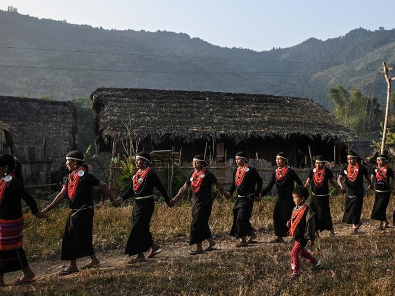 This photo taken on February 7, 2020 shows the end of an overnight ceremony to bless the harvest by Naga tribeswomen in Satpalaw Shaung village, Lahe township in Myanmar's Sagaing region. A haunting refrain pierces the night as the tribeswomen of the Gongwang Bonyo, among the most isolated people in Myanmar, dance around a campfire to bless the harvest ahead. Ye Aung THU / AFP
