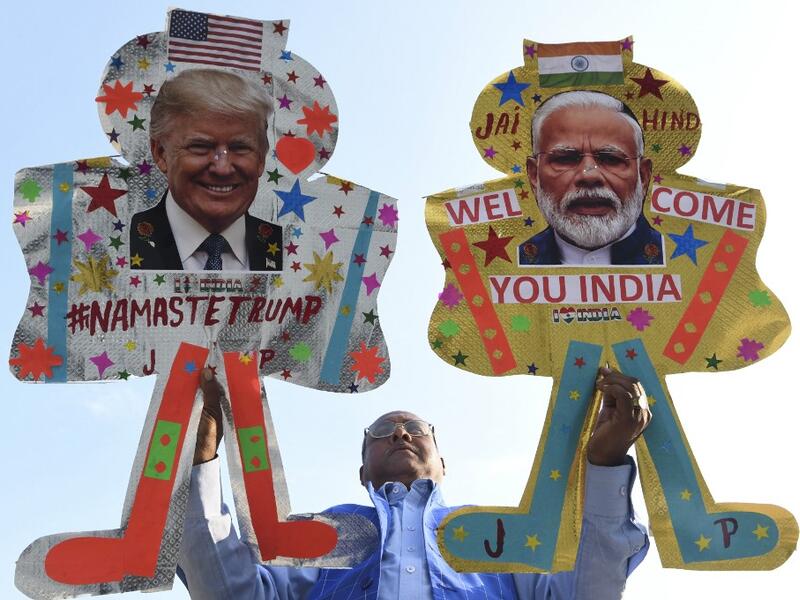 Kite-maker Jagmohan Kanojia (C) poses with kites decorated with the pictures of US President Donald Trump (R) and India's Prime Minister Narendra Modi, in Amritsar on February 23, 2020, ahead of Trump's visit to India. Trump makes his first official visit to India on February 24. NARINDER NANU / AFP