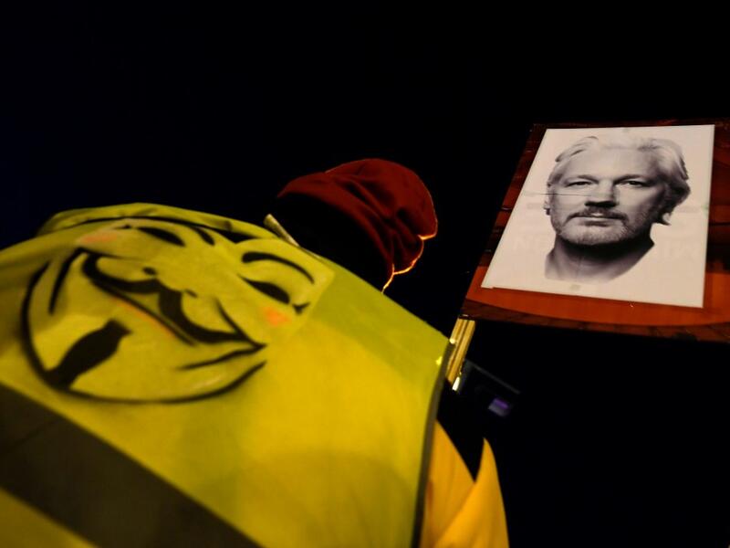 A demonstrator holds a picture of WikiLeaks founder Julian Assange during a supporting protest called by Catalan National Assembly (ANC) under the motto "Journalism is not a crime" in Barcelona on February 24, 2020. A British court today started hearing Washington's extradition request for WikiLeaks founder Julian Assange in a test case of media freedoms in the digital age and the global limits of US justice. LLUIS GENE / AFP