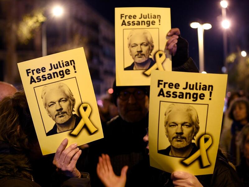 Demonstrators hold signs during a protest called by Catalan National Assembly (ANC) under the motto "Journalism is not a crime" to support WikiLeaks founder Julian Assange in Barcelona on February 24, 2020. A British court today starts hearing Washington's extradition request for WikiLeaks founder Julian Assange in a test case of media freedoms in the digital age and the global limits of US justice. LLUIS GENE / AFP