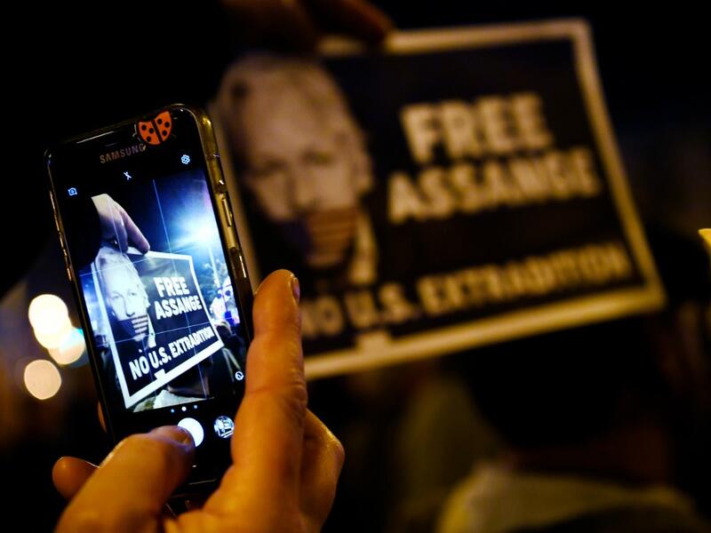 A demonstrator takes a picture with a smartphone during a protest called by Catalan National Assembly (ANC) under the motto "Journalism is not a crime" to support WikiLeaks founder Julian Assange in Barcelona on February 24, 2020. A British court today starts hearing Washington's extradition request for WikiLeaks founder Julian Assange in a test case of media freedoms in the digital age and the global limits of US justice. LLUIS GENE / AFP