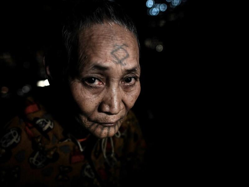 This photo taken on February 6, 2020 shows Khamyo Pon Nyun, 75, a tattooed Lainong tribeswoman resting at her house at Lahel township in Sagaing region of Myanmar, wedged in a semi-autonomous zone near the Indian border. People in the region subscribe to a complex patchwork of customs, intertwining their animist beliefs with warrior traditions that include striking tattoo designs, which can signify tribal identity, life accomplishments or the completion of a rite of passage. Ye Aung THU / AFP