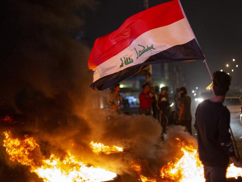 Anti-government demonstrators block a street with burning tyres during a protest in the southern Iraqi city of Basra on February 25, 2020. Hussein FALEH / AFP